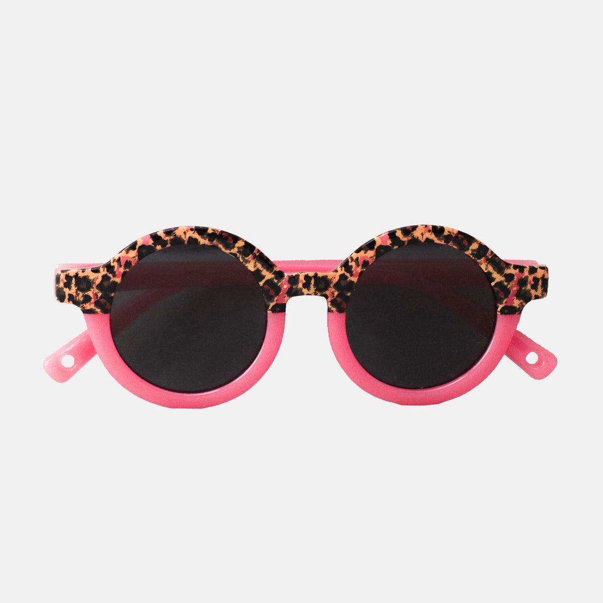 Paire de lunettes de soleil bébé catégorie 4, monture en TPEE effet transparent couleur rose avec motif léopard sur le haut. 